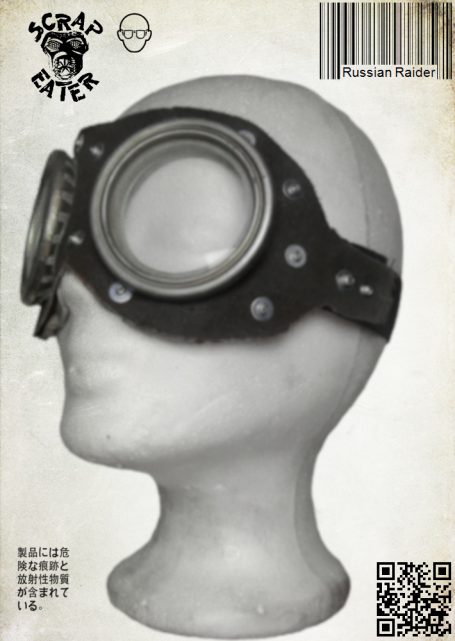 Safety goggles with two round lenses, black strap, leather trim, and metal rivets.
